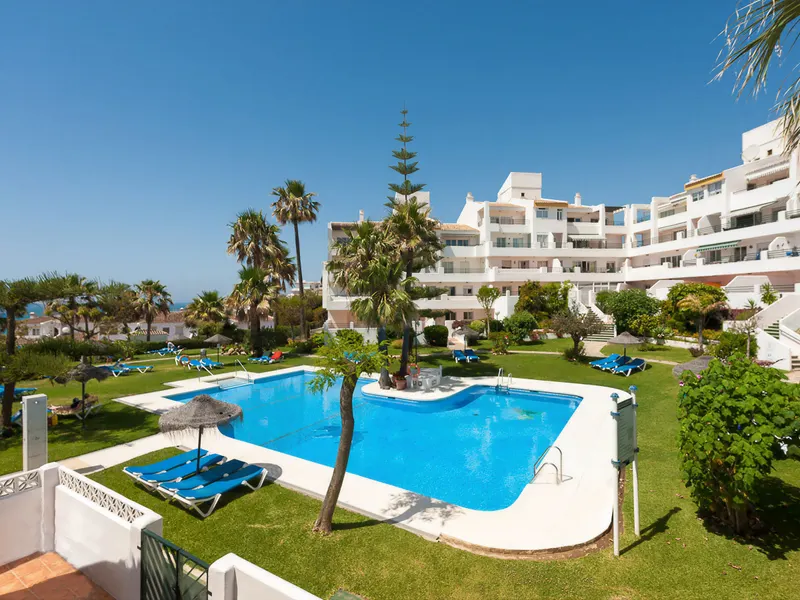Pool area with gardens and sun loungers
